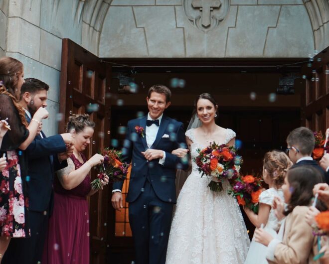 Man and woman walking out of a building after getting married. Confetti being thrown at them.