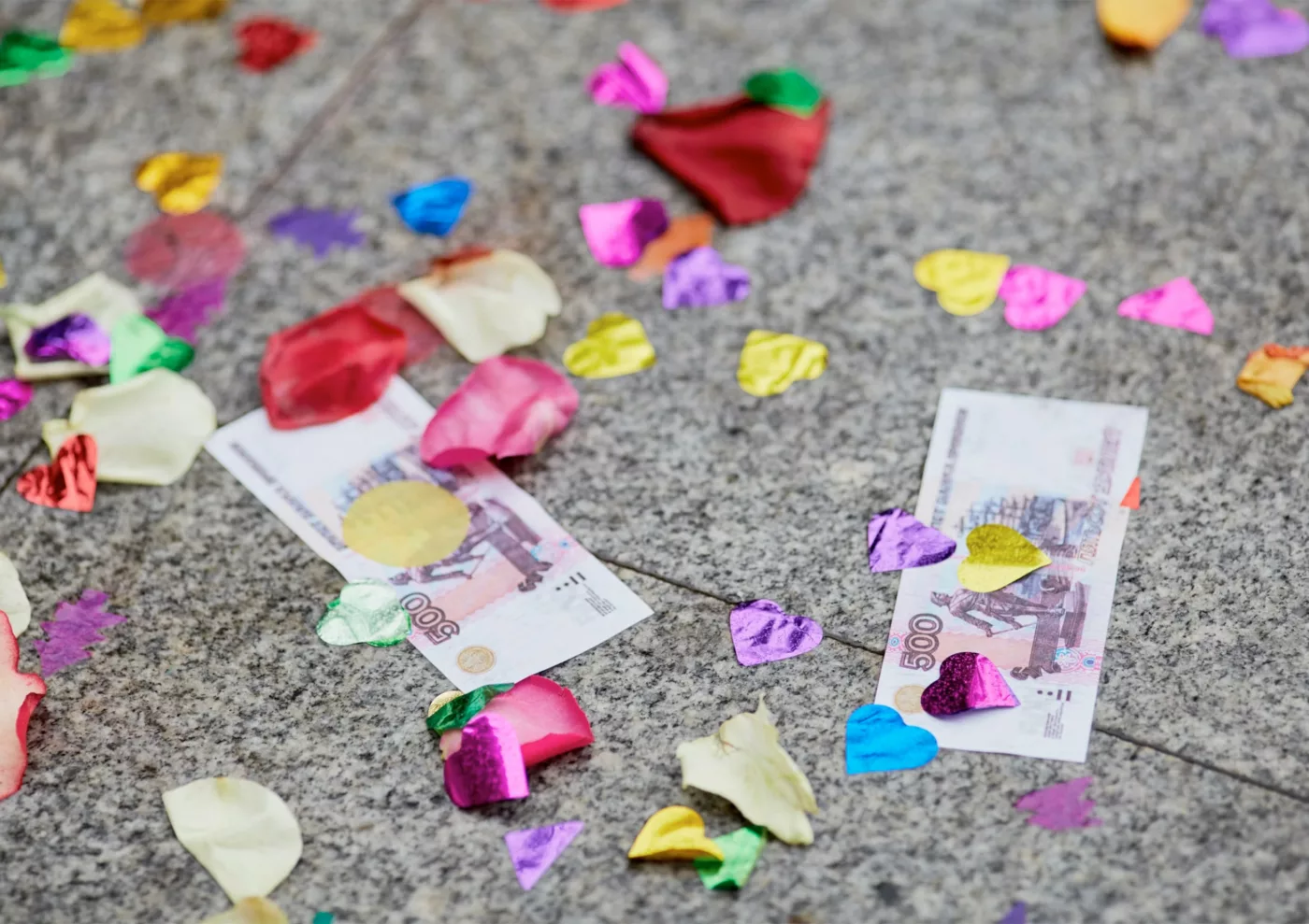 Money underneath multicoloured confetti