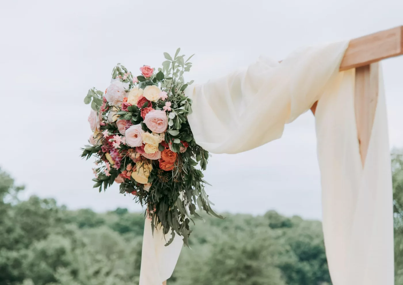 A bouquet of flowers on hanging on a wooden frame