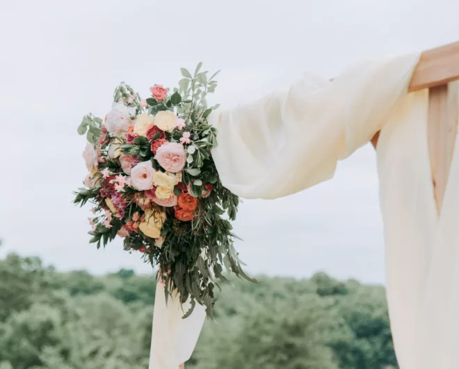 A bouquet of flowers on hanging on a wooden frame